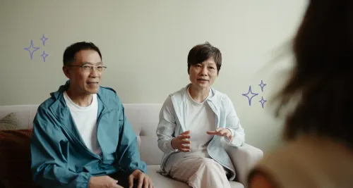 Two clients sitting across from a therapist during a couples therapy session, representing group therapy documentation and AI scribe notes for multi-participant sessions