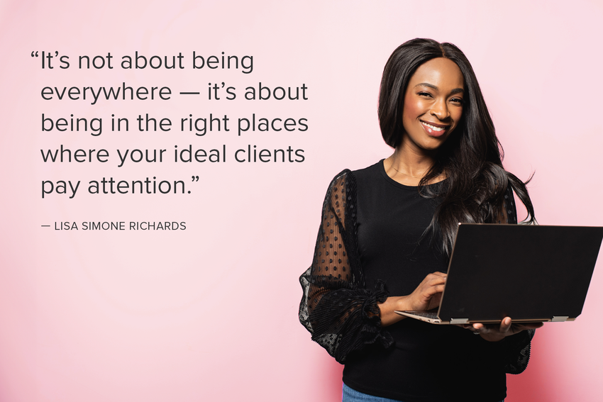 Lisa Simone stands with a laptop in her hands and smiles at the camera. She wears a black top with black polka dotted sleeves, a gold necklace, and jeans. The background is pink behind her and there is a pull-quote to her left: "It's not about being everywhere — it's about being in the right places where your ideal clients pay attention.