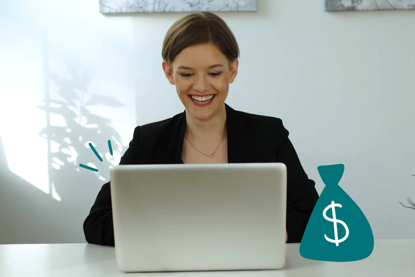 Julia Smith looks at her laptop and smiles. She has her brown tied back and wears a black blazer and silver necklace. She is at a desk in her clinic with a white background and the shadow of a plant behind her. Illustrated elements around the laptop include three teal lines in the upper left corner of the laptop to signal a notification, and a teal-colored bag of money to the right of the laptop on the table.