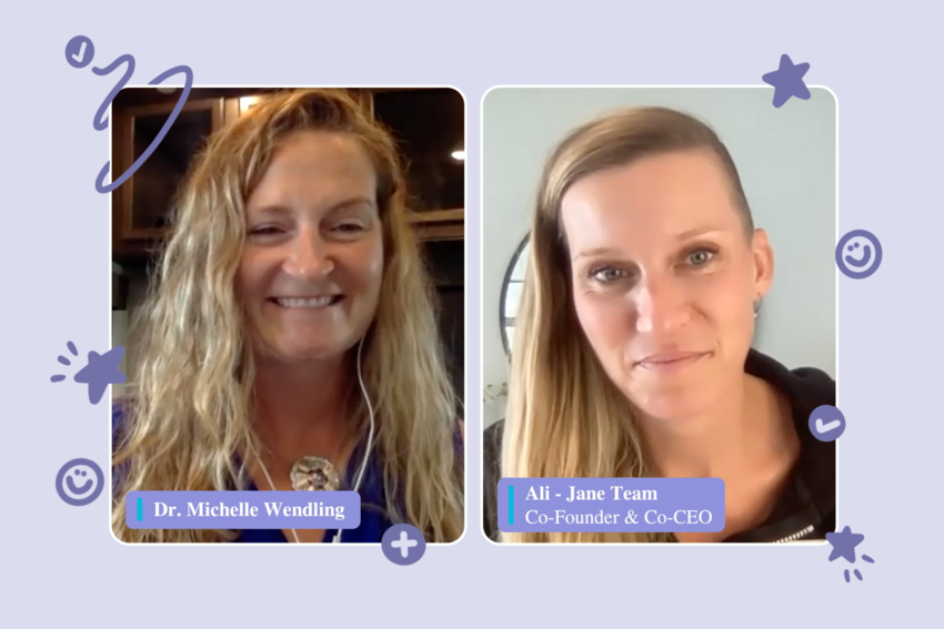 A screenshot of two side-by-side Zoom presentation screens: on the left, Dr. Michelle Wendling, and on the right, Ali Taylor, Co-Founder and Co-CEO of Jane. Michelle smiles and has long, wavy blonde hair. She wears a blue top with a circular silver necklace. In the background, we see dark cupboards. To her right, Ali listens intently. She wears a black zip-up hoodie. In the background, we see the edge of a round mirror and white walls. There is a purple illustrated background around them with design like smiley faces, stars, check marks, and plus signs. Below each of their screens are their respective titles in a lower-third, white text on purple background: "Dr. Michelle Wendling" and "Ali - Jane Team, Co-Founder and Co-CEO"