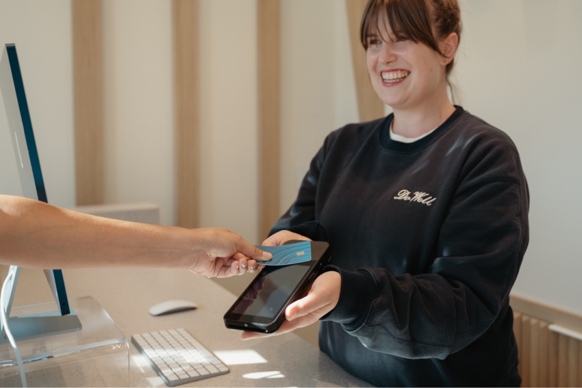Admin staff helping a patient pay their bill